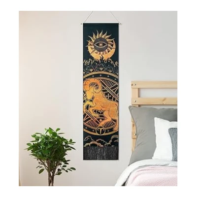 Image of Aries Constellation Tapestry with a wall hanging featuring a ram constellation design in gold and black, hung above a bed with a plant nearby