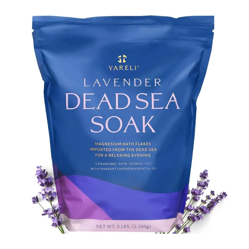 Image of a blue Yareli Dead Sea bath soak package labeled "Lavender," with purple lavender sprigs, on a white background