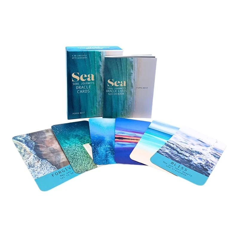 Image of a set of sea-themed oracle cards with a box and fanned-out cards featuring ocean scenes, on a white background