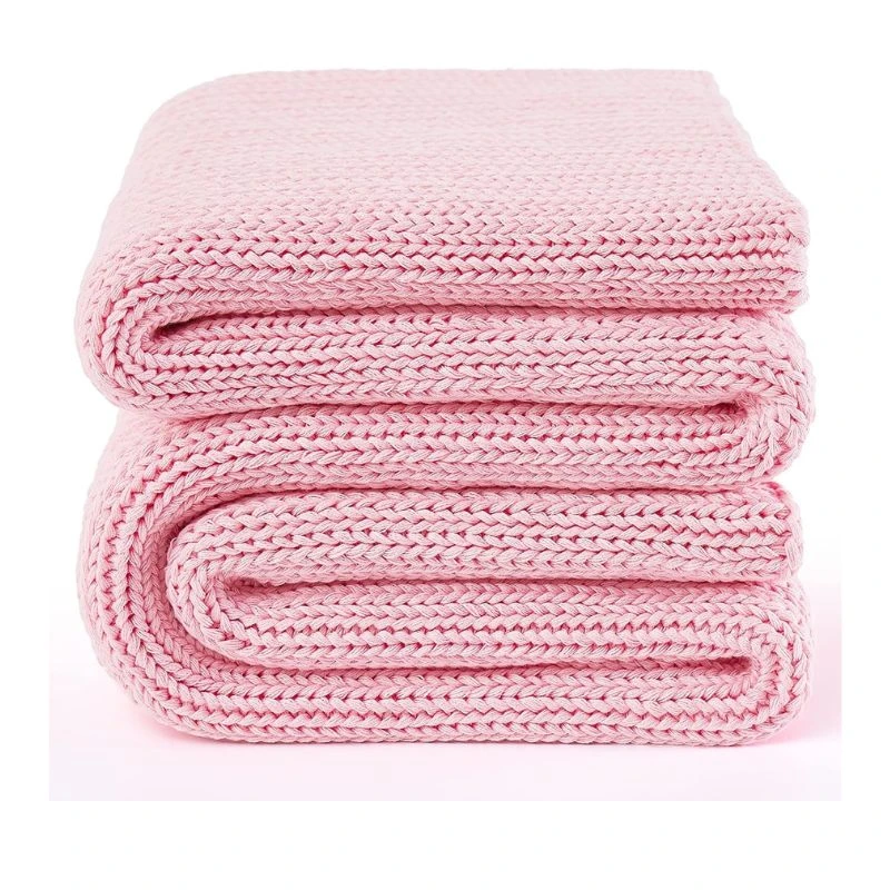 Image of a folded pink weighted blanket, knitted texture visible, on a white background