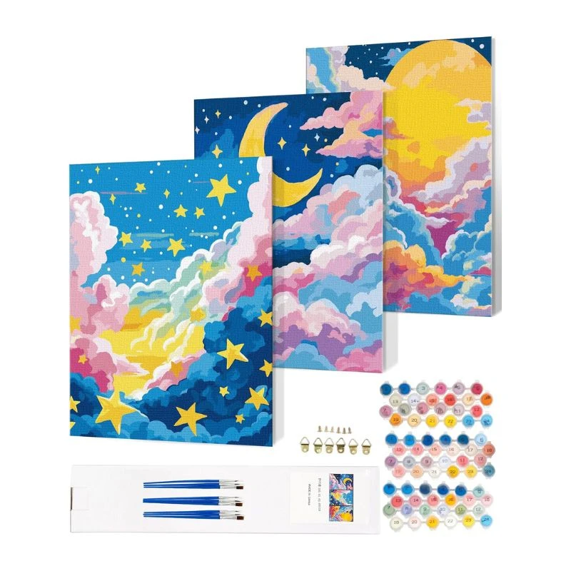 Image of a lunar-themed paint by number kit with three canvases featuring moon and cloud designs, paint pots, and brushes, on a white background